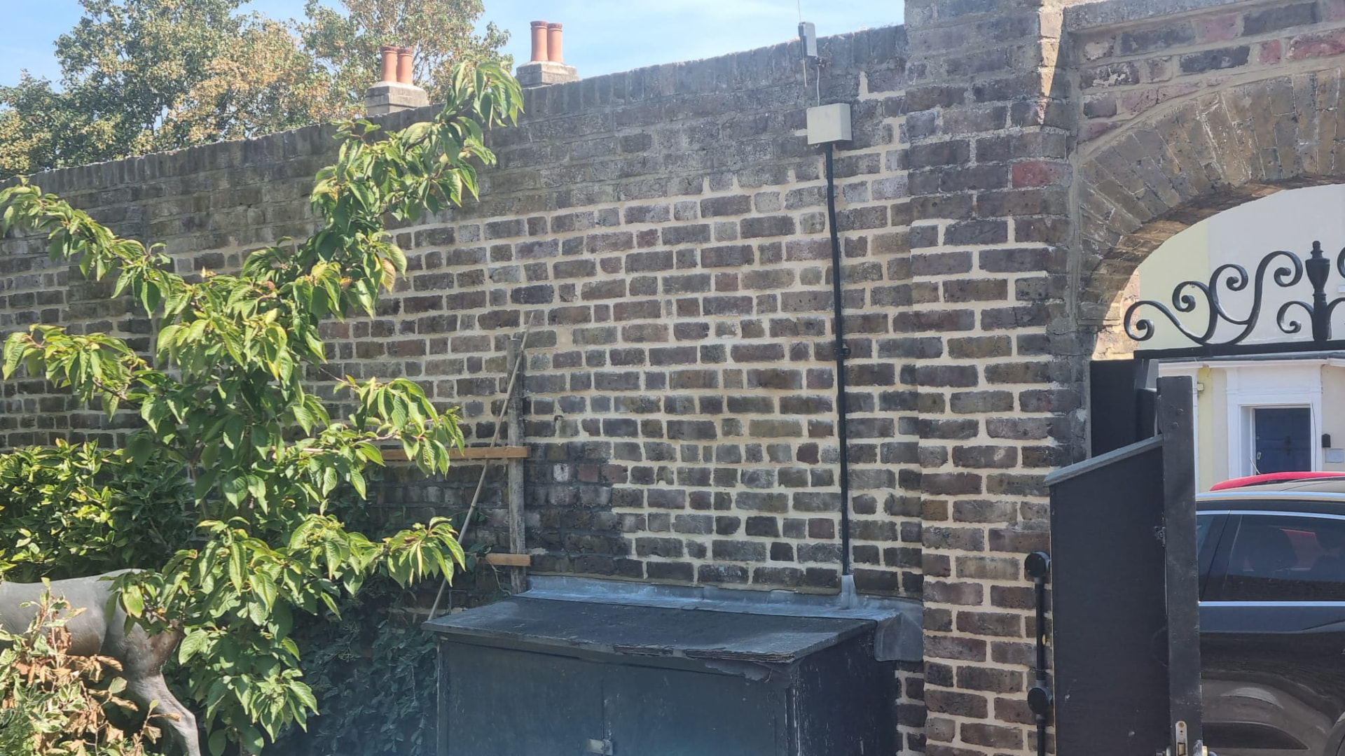 The same Hampton garden wall after being repointed in lime mortar with a flush joint